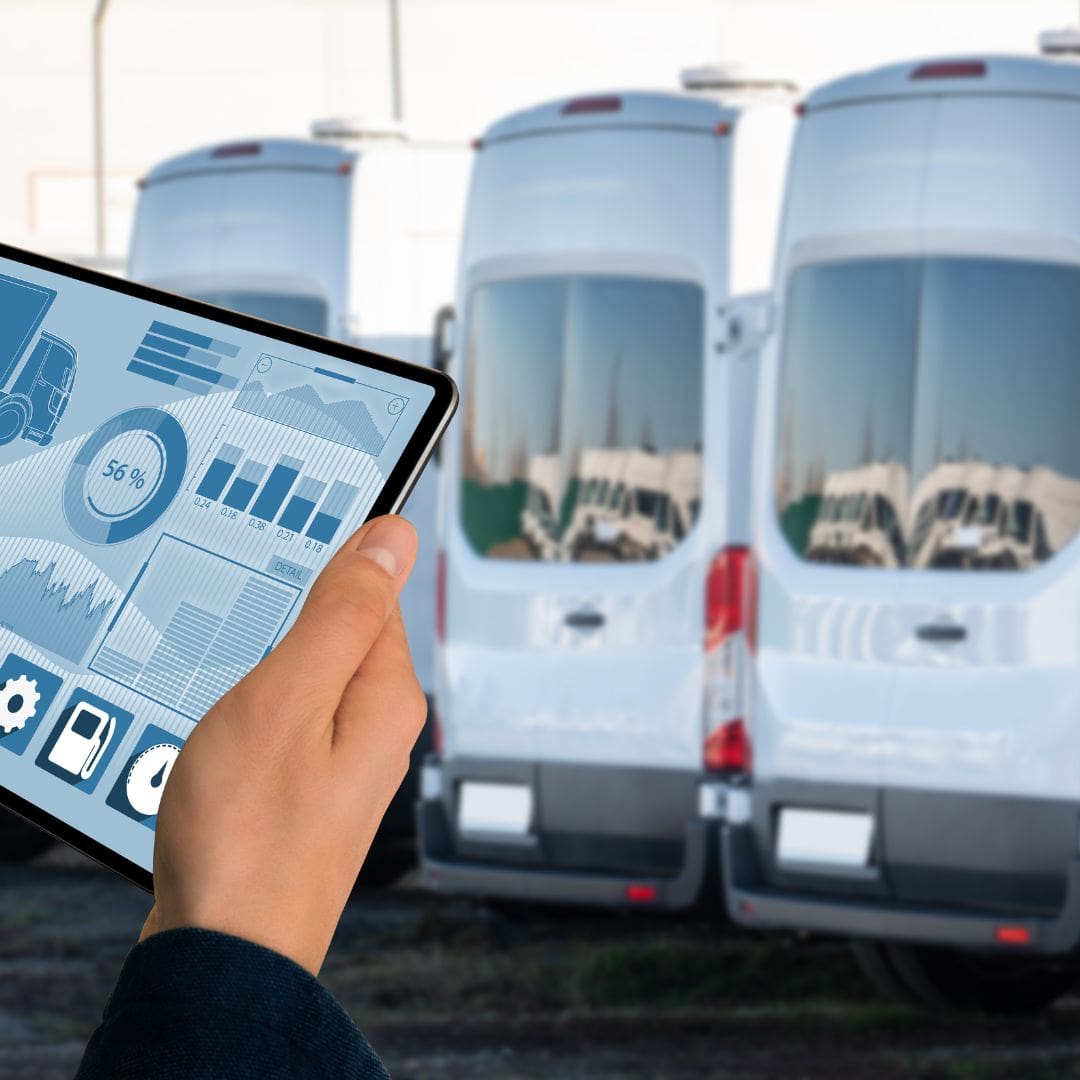 holding a tablet looking at fleet vehicles