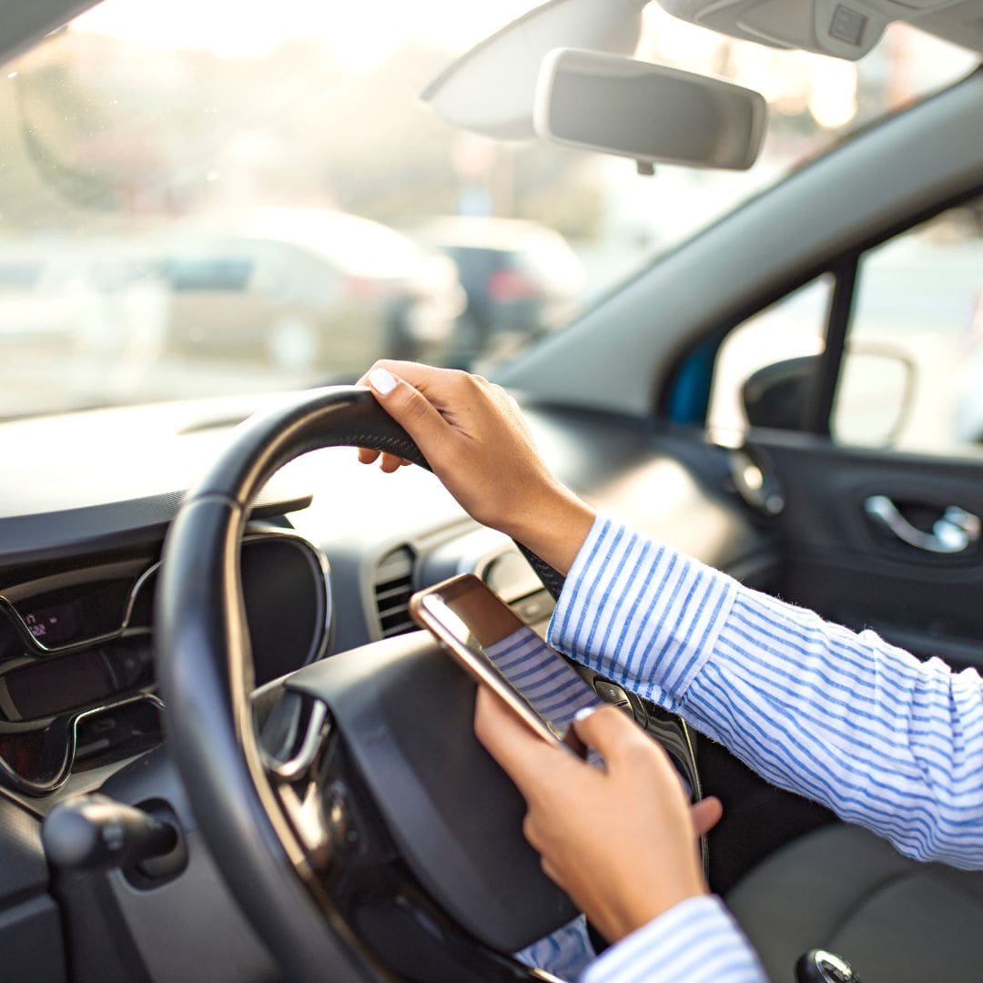 Business woman texting and driving