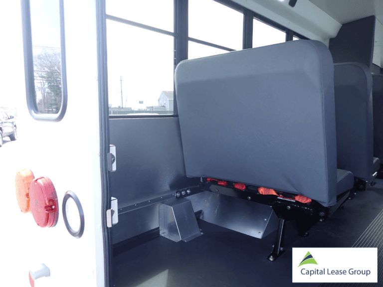 Rear storage area inside a school activity bus for equipment, bags, and trip supplies.