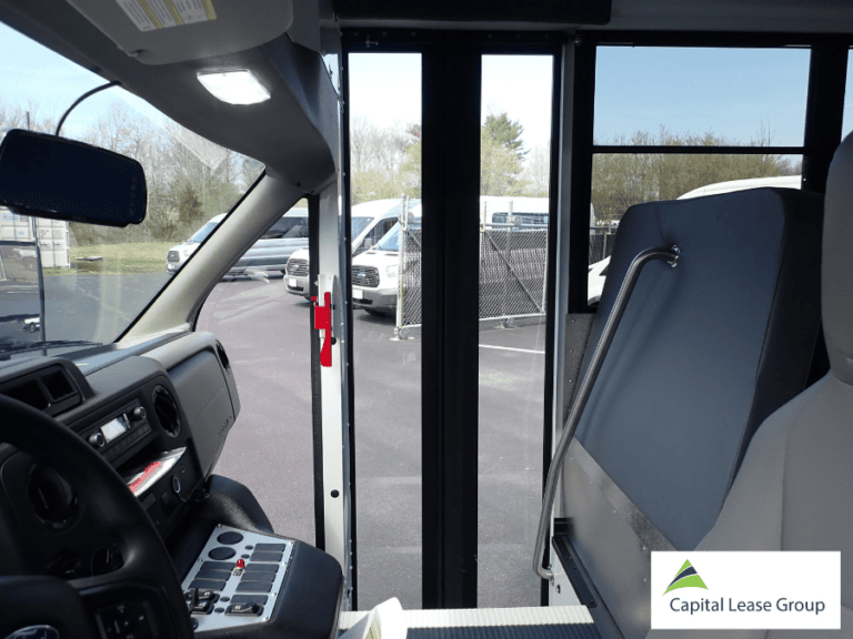 Passenger entrance of a school activity bus with step access and handrail.