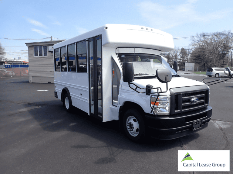 Exterior passenger-side angle of a white school activity bus.