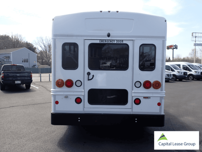 Rear exterior view of a school activity bus with emergency door.