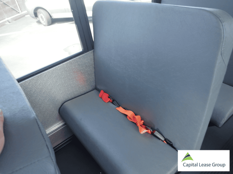 Passenger seatbelt inside a school activity bus.